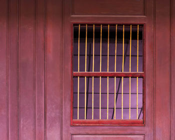 Old window shutters in wooden wall.