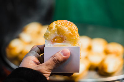 Close-up of hand holding ice cream