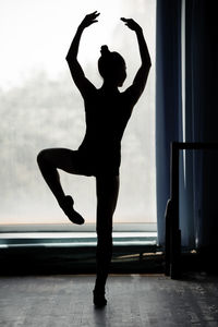 Silhouette ballet dancer practicing at ballet studio