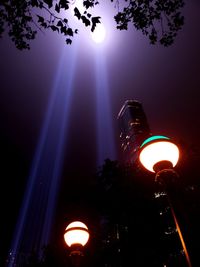 Low angle view of illuminated lights against sky at night