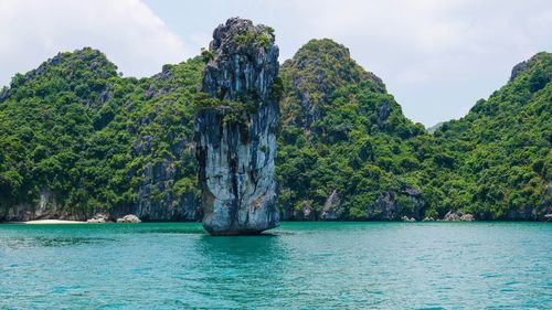 Scenic view of rocks in sea against sky