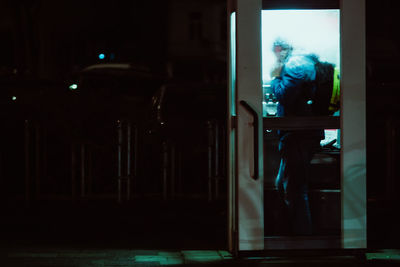 Man in illuminated room