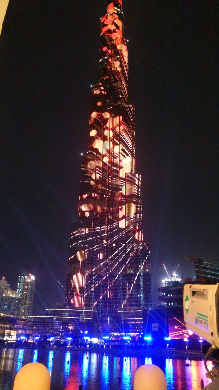 VIEW OF ILLUMINATED CITY AT NIGHT