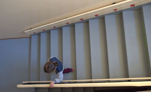 High angle view of boy moving down on steps