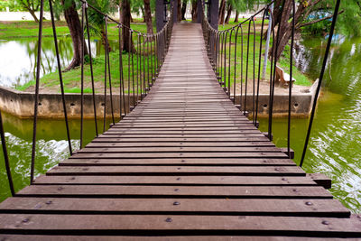 Empty footbridge along plants