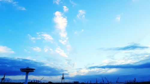 Low angle view of silhouette trees against cloudy sky