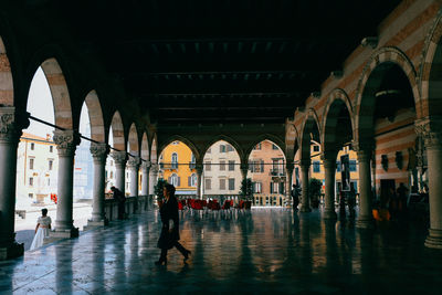 People walking in corridor of building