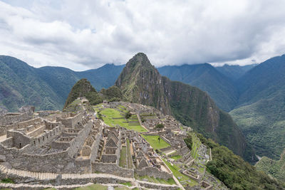 High angle view of ruins of mountain against cloudy sky