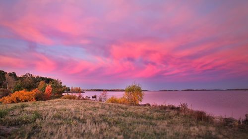 View of calm lake against scenic sky