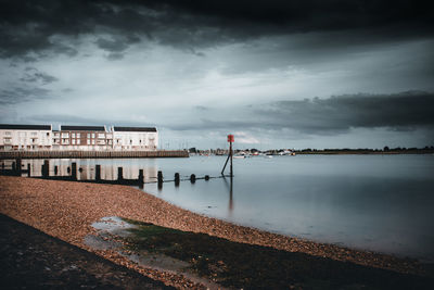 Building by sea against sky