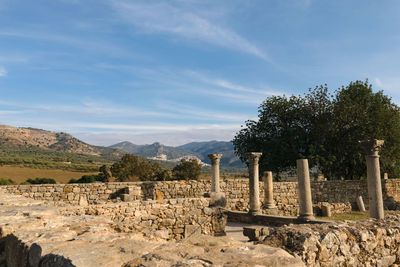 View of ruins of building against cloudy sky