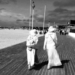 Rear view of woman standing against sky