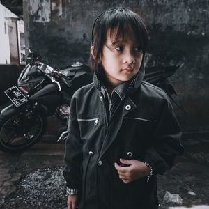 Portrait of girl standing on motorcycle