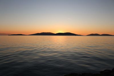 Scenic view of sea against romantic sky at sunset