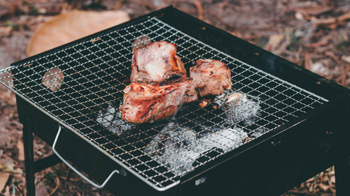 High angle view of meat on barbecue grill