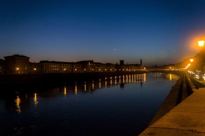 Reflection of buildings in river at night