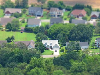 High angle view of trees and houses on field