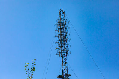 Low angle view of electricity pylon against sky