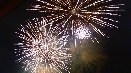 Low angle view of firework display at night