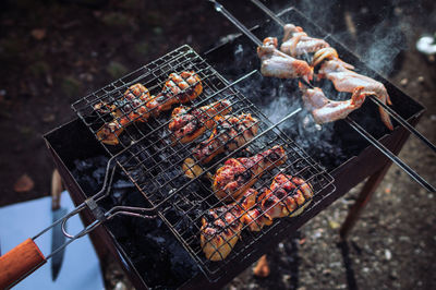 High angle view of meat on barbecue grill