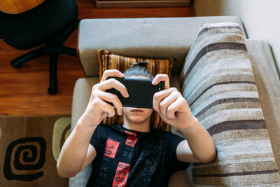 Digital addiction in tweens and teens, smartphone addicted. teenage boy playing online game