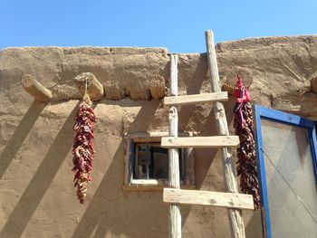 An adobe home in taos, new mexico with chiles hanging out to dry.