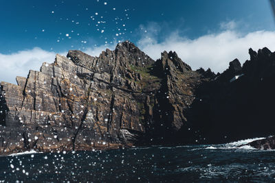 Scenic view of sea and mountains against sky