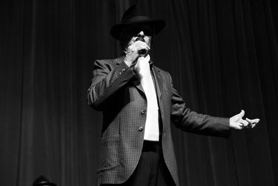 Low angle view of man singing while standing on stage