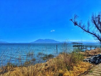 Scenic view of sea against blue sky