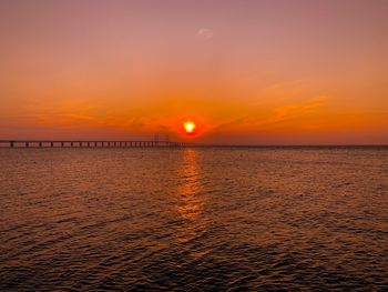 Scenic view of sea against orange sky