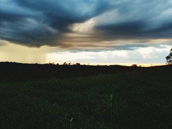 Scenic view of field against sky during sunset