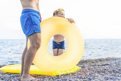 Portrait of young woman exercising on beach