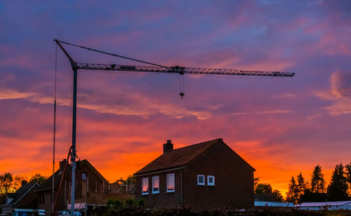 Low angle view of silhouette buildings against sky during sunset