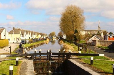 View of canal against cloudy sky