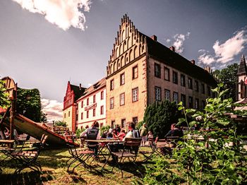 People in front of buildings against sky