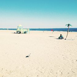 Scenic view of beach against clear sky