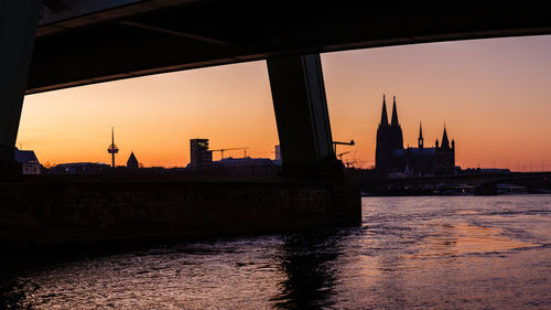 View of city at waterfront during sunset