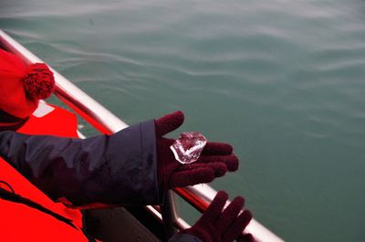 Low section of man on red boat