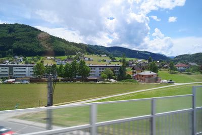 High angle view of agricultural field against houses