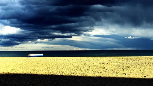 Scenic view of sea against storm clouds