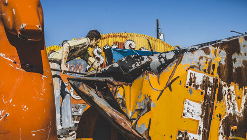 Yellow abandoned building against clear blue sky