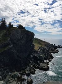 Scenic view of rocks on sea against sky