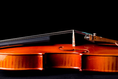 Close-up of guitar against black background