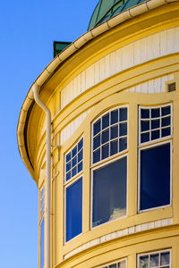 Low angle view of building against clear blue sky