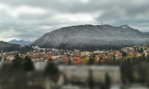 High angle shot of townscape against cloudy sky