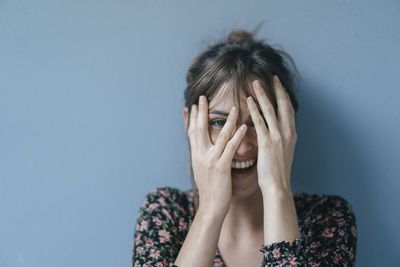 Beautiful woman covering face, portrait