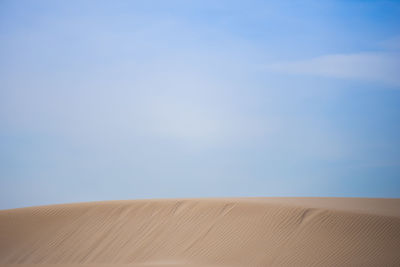 Scenic view of desert against clear blue sky