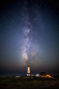 Lighthouse against sky at night