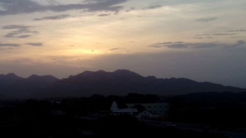 Scenic view of mountains against sky at sunset