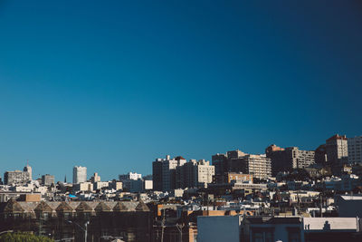 Cityscape against clear blue sky